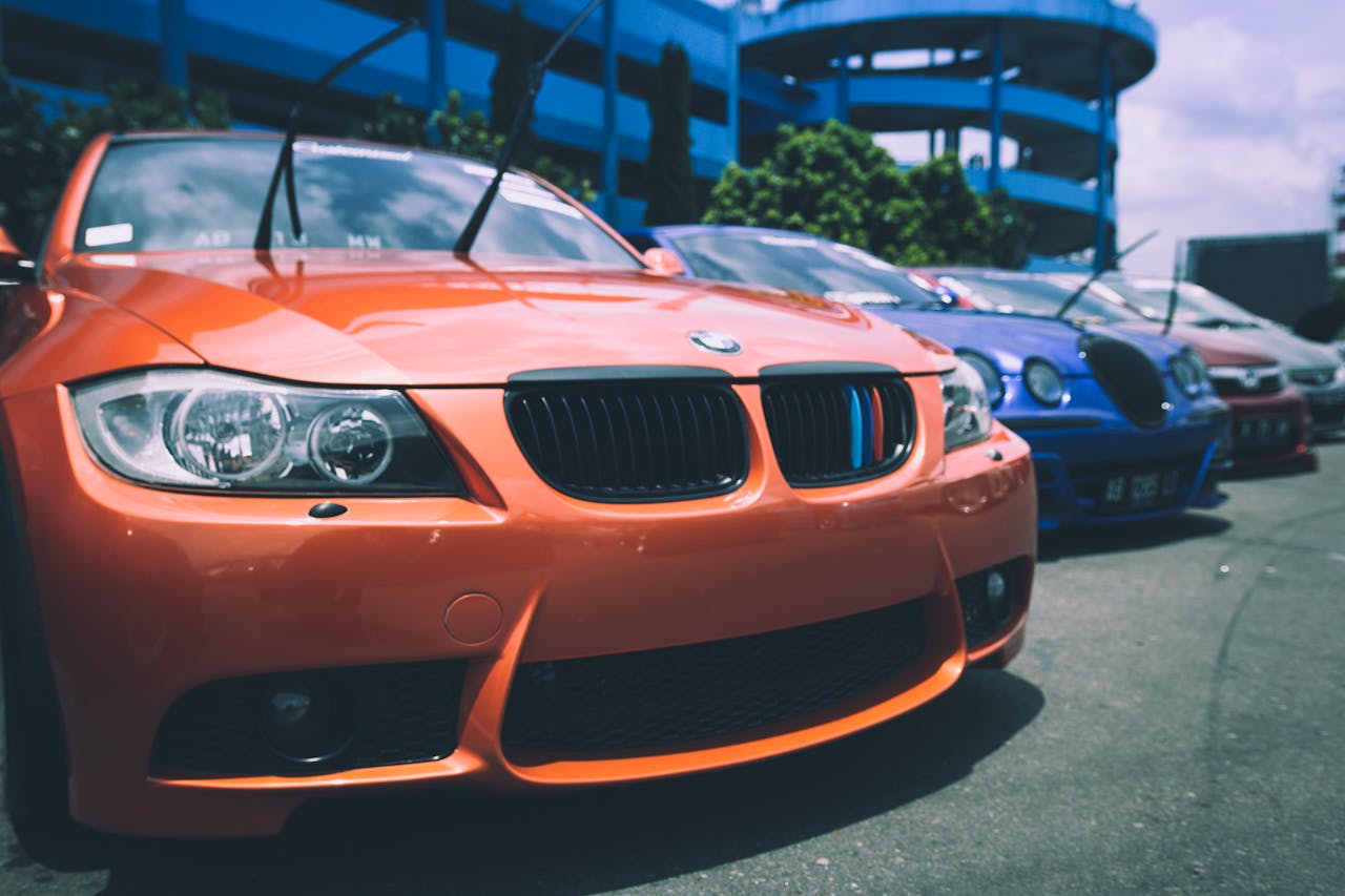 about-02 Vibrant BMW cars parked outdoors showcasing an array of colors and designs.